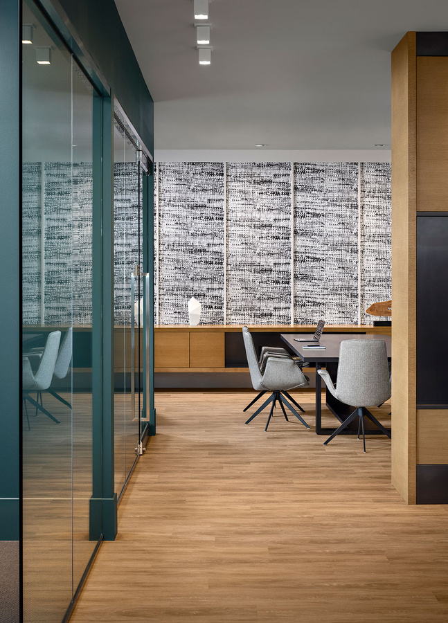 a modern office with wooden floors and glass walls for focused quiet co-working 