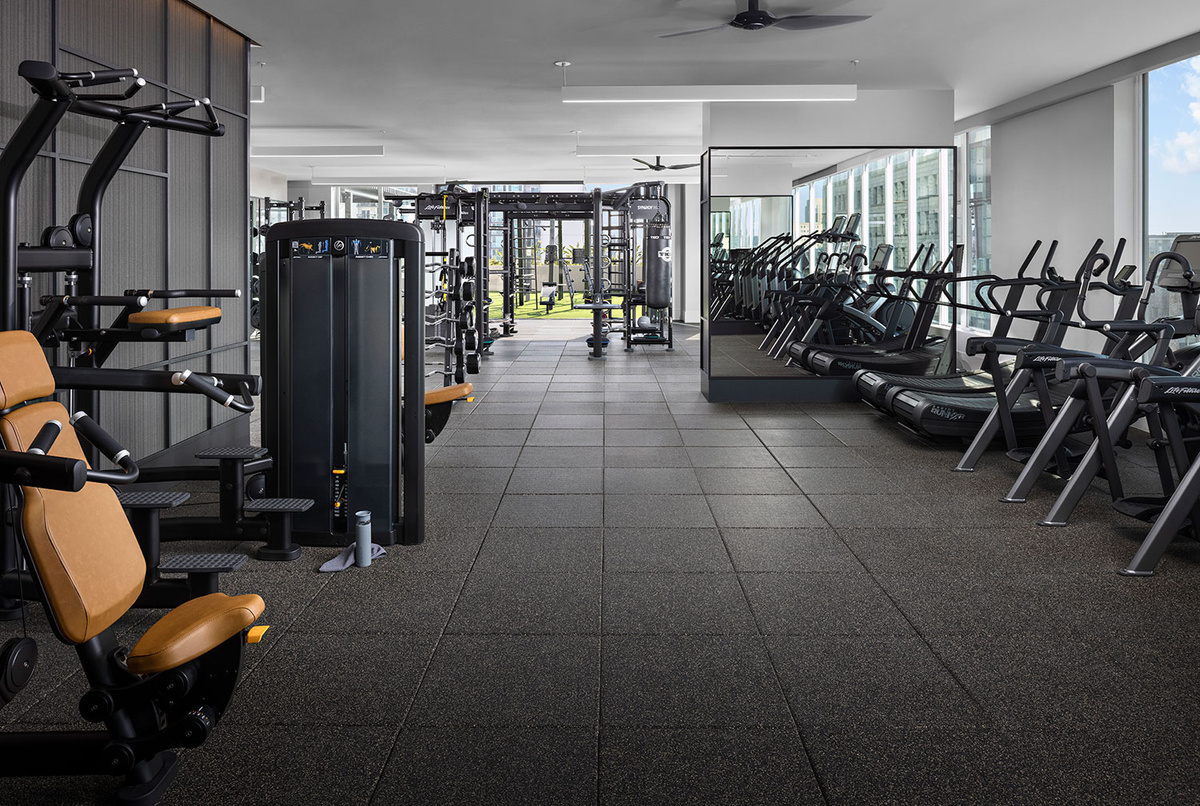 a gym room with weights, machines and mirrors outdoor gym area inspired by equinox fitness and wellness design